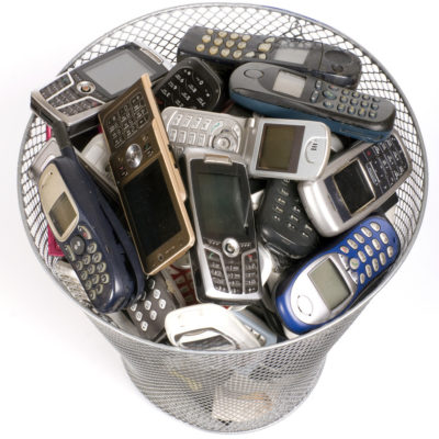 rubbish bin full of old cell phones